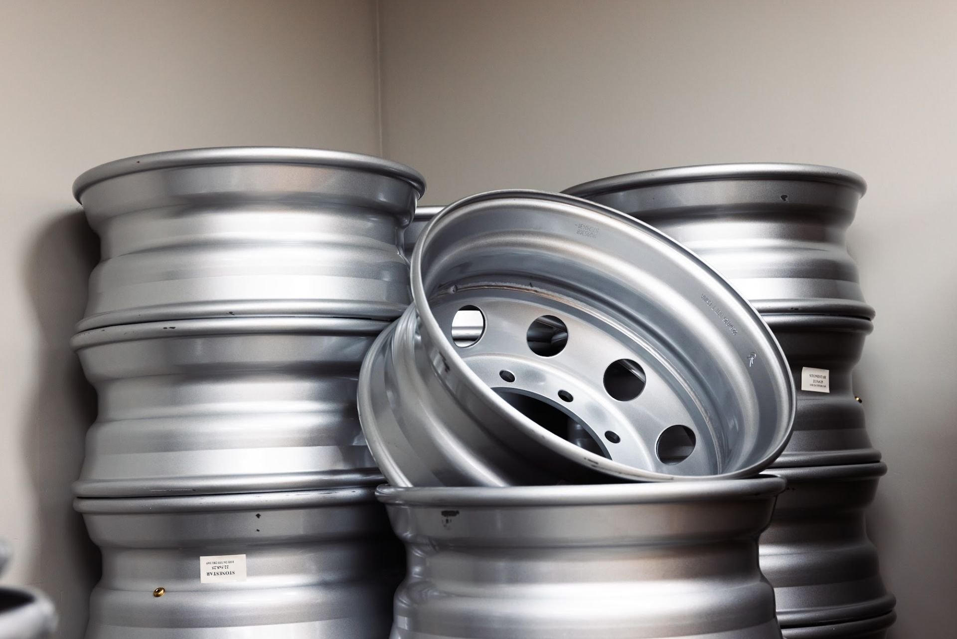 Truck wheel rims stacked in the Infinity Tyres warehouse
